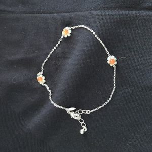 Silver anklet with beaded flower accents.